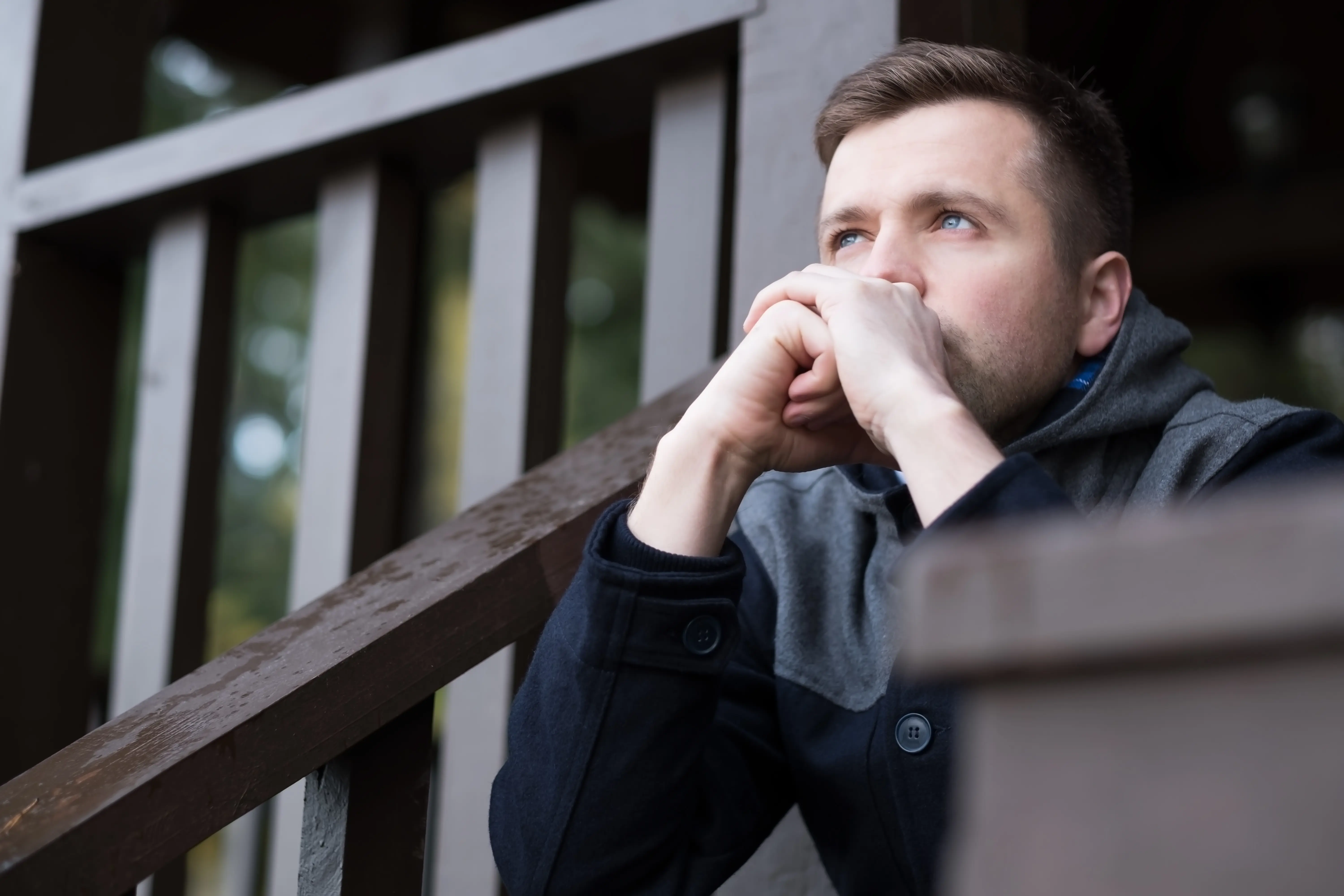 Man Sat On Outdoor Stairs