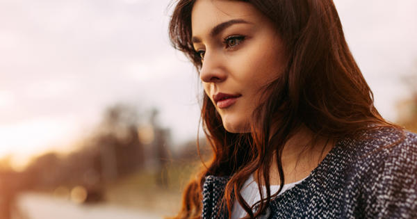 Young Woman Walking Along Road