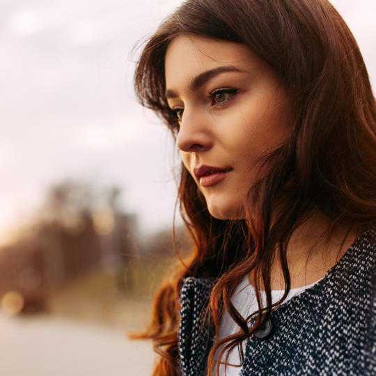 Young Woman Walking Along Road